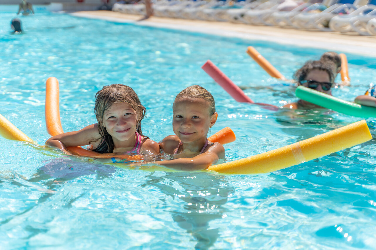 Happy children in the swimming pool at CAPFUN Serra de Prades campsite in Vilanova de Prades.