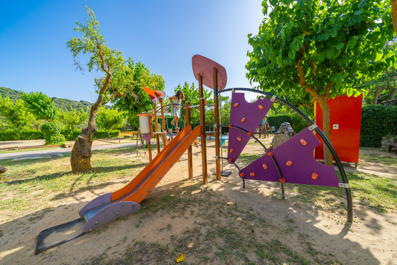 Playground with slide and climbing structures for children at CAPFUN Serra de Prades campsite (43).