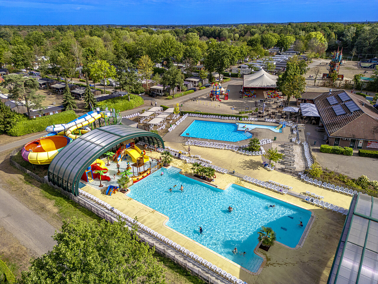 Aerial view of the water park with slides and pools at CAPFUN Rakelbos campsite in Westelbeers.
