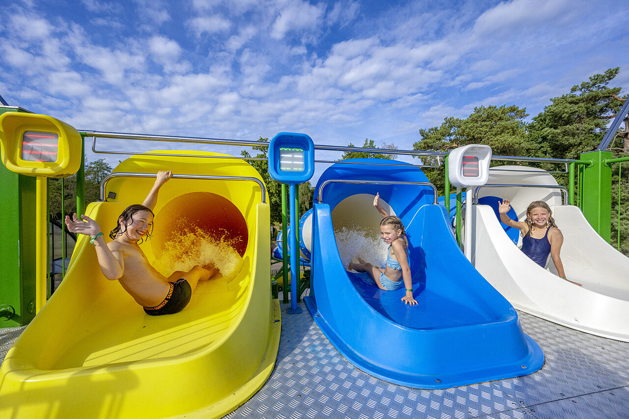 Children enjoying colorful water slides at CAPFUN Rakelbos campsite in Westelbeers.