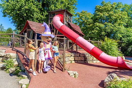 Playground with slide and mascot at CAPFUN R�gni�re campsite in VILLETTE D'ANTHON.