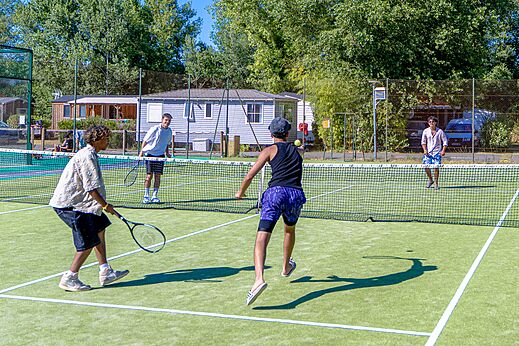 Tennis match on the multisport court at CAPFUN R�gni�re campsite in VILLETTE D'ANTHON.