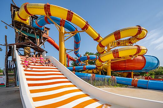 Outdoor pool and water slides at CAPFUN Roumingue campsite in LANTON (33).