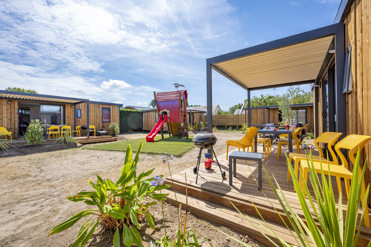 Mobile home, terrace, barbecue and playground at CAPFUN La Route Blanche campsite in Breville sur Mer.