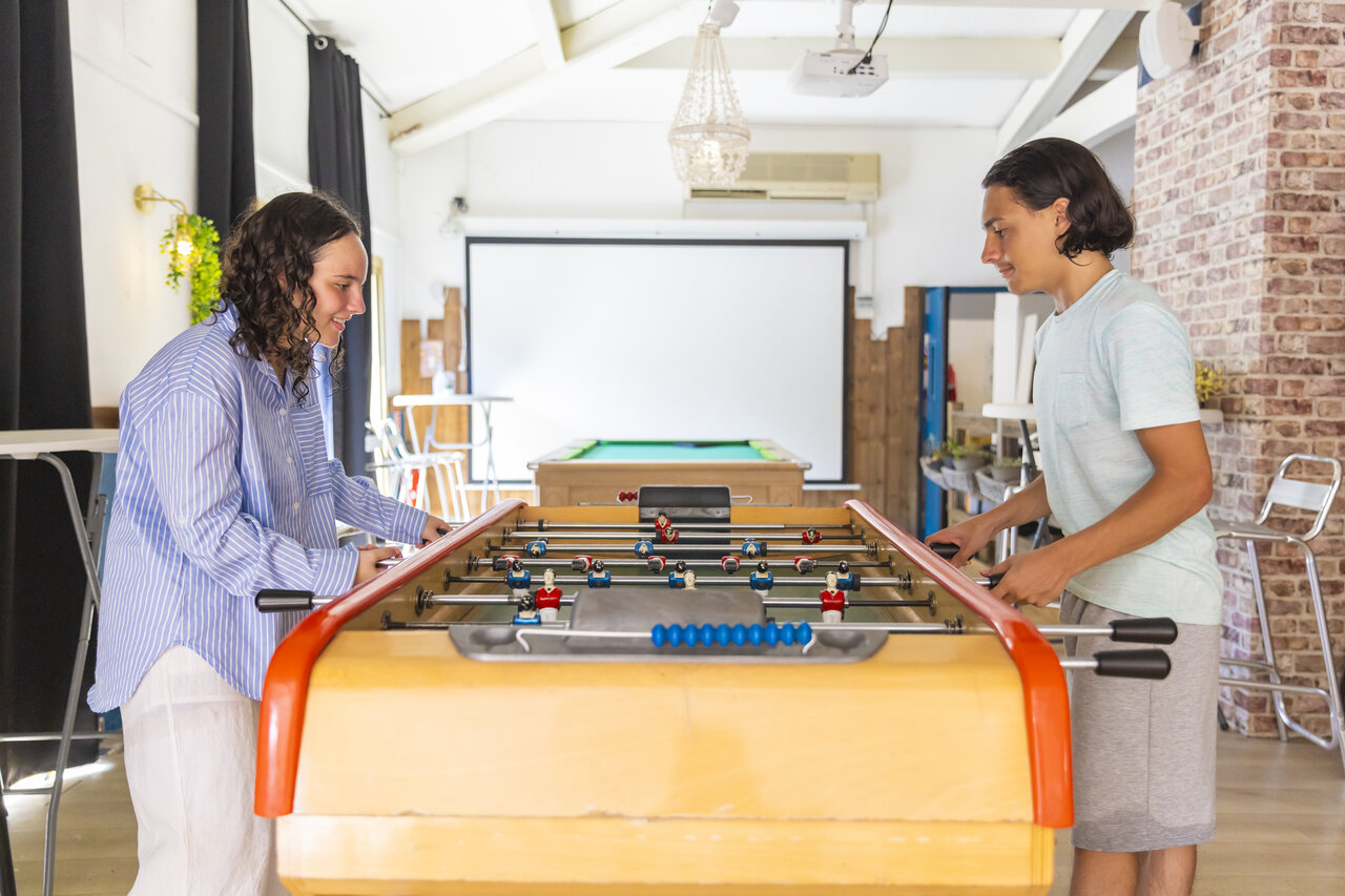 Foosball, smiling young people, game room at CAPFUN La Rumba campsite Fr�jus (83).