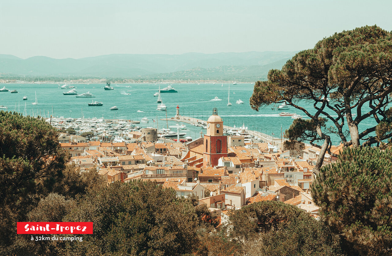Port of Saint-Tropez, its bell tower and yachts, iconic place to visit.