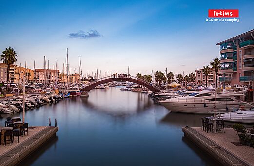 Fréjus marina, its boats and iconic pedestrian bridge.