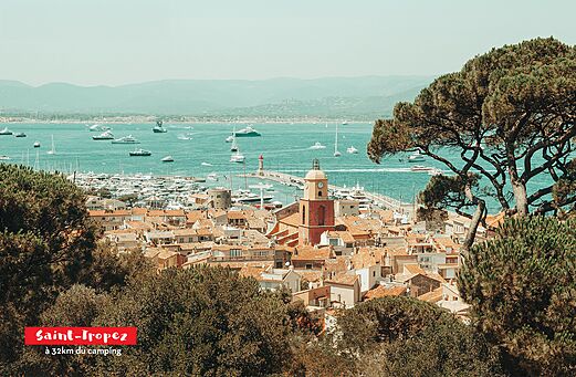 Panoramic view of Saint-Tropez, its lively port and iconic bell tower.