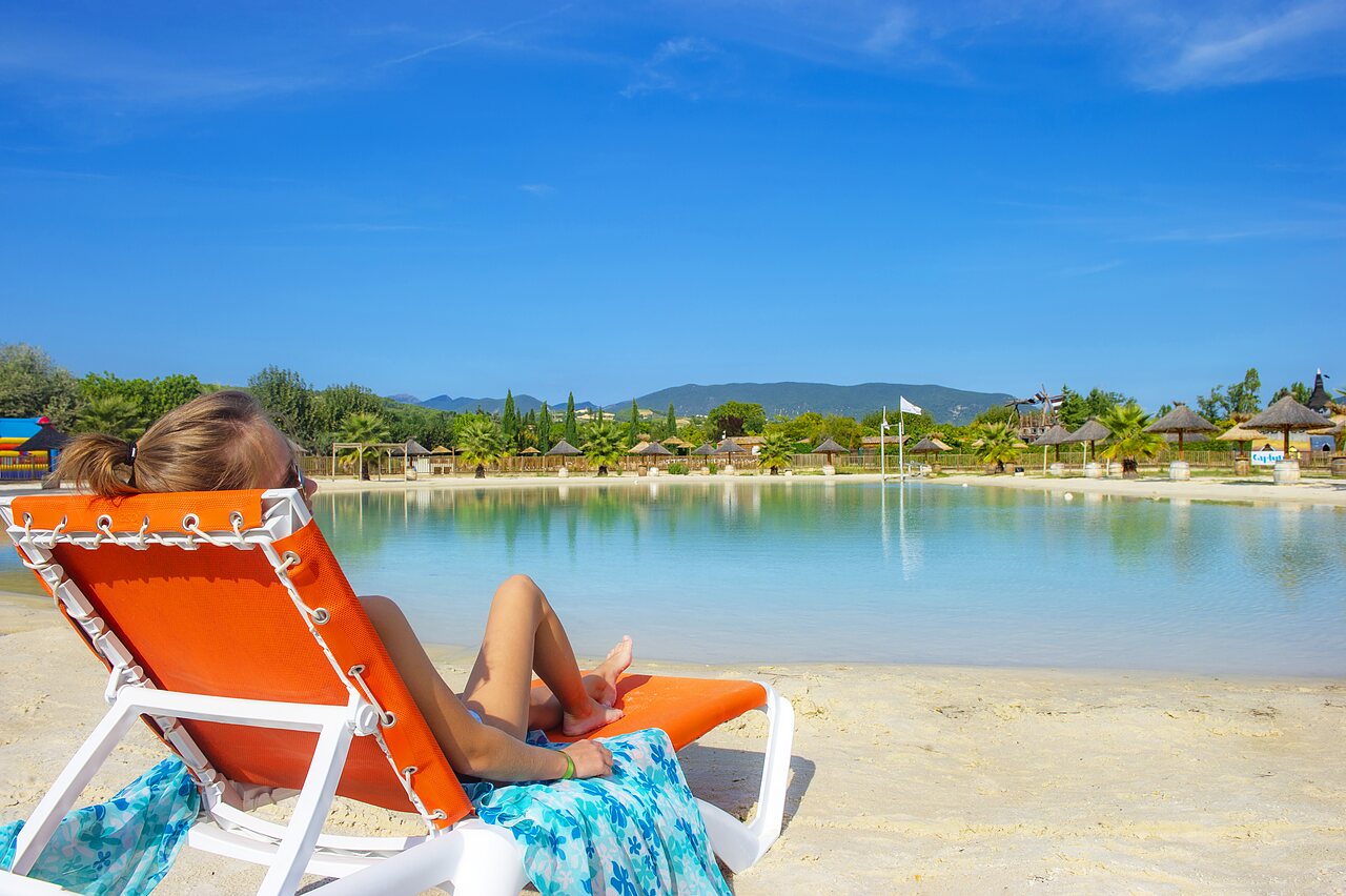 Lagoon, sandy beach and sun lounger at CAPFUN Sagittaire campsite in VINSOBRES (26).