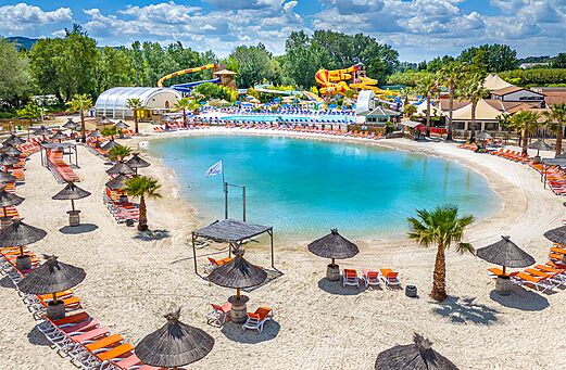 Lagoon pool, sandy beach and chairs at CAPFUN Sagittaire campsite in VINSOBRES (26).