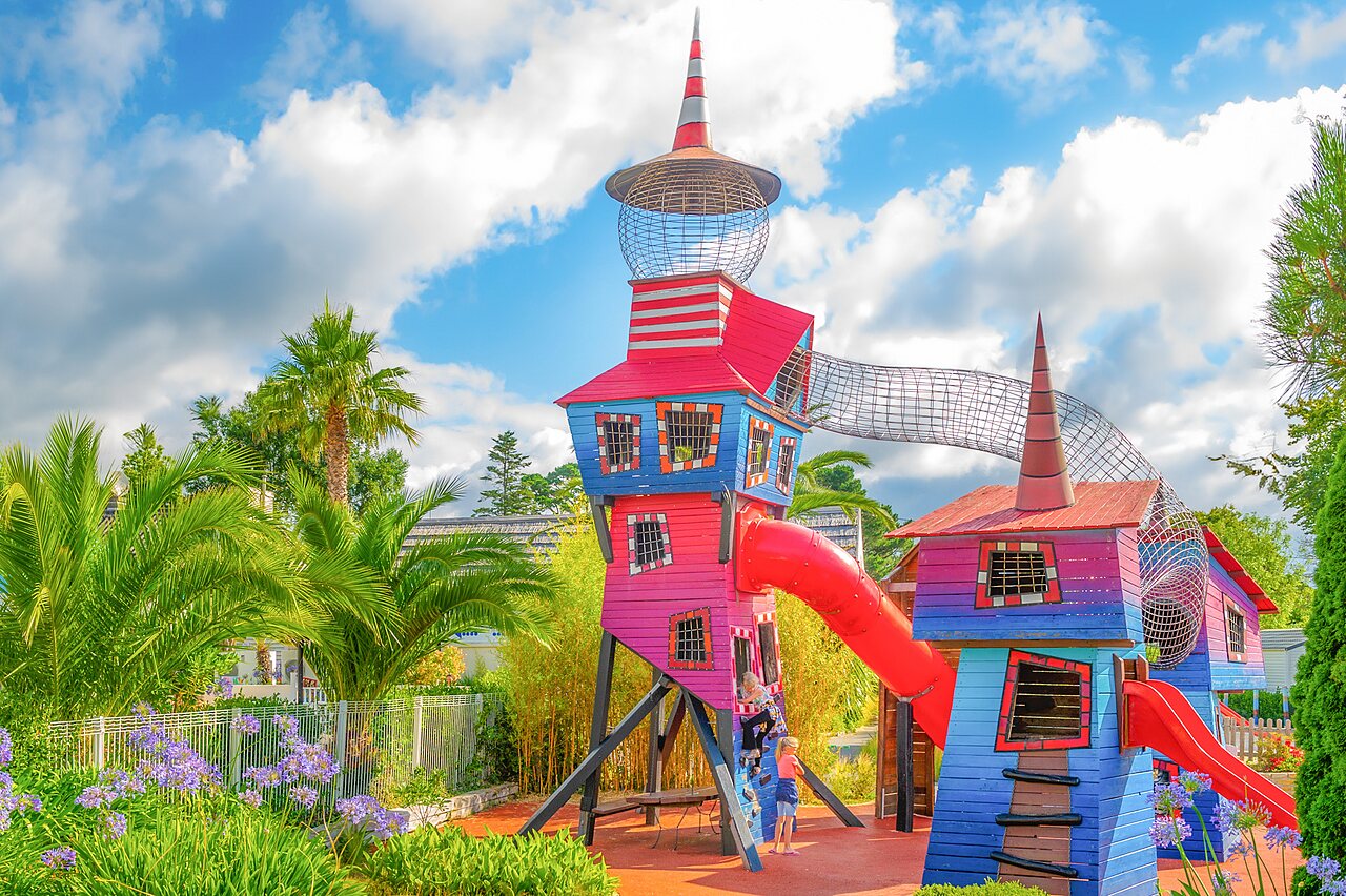 Colorful playground with slides and climbing structures at CAPFUN Saint Laurent campsite in LA FORET FOUESNANT (29).