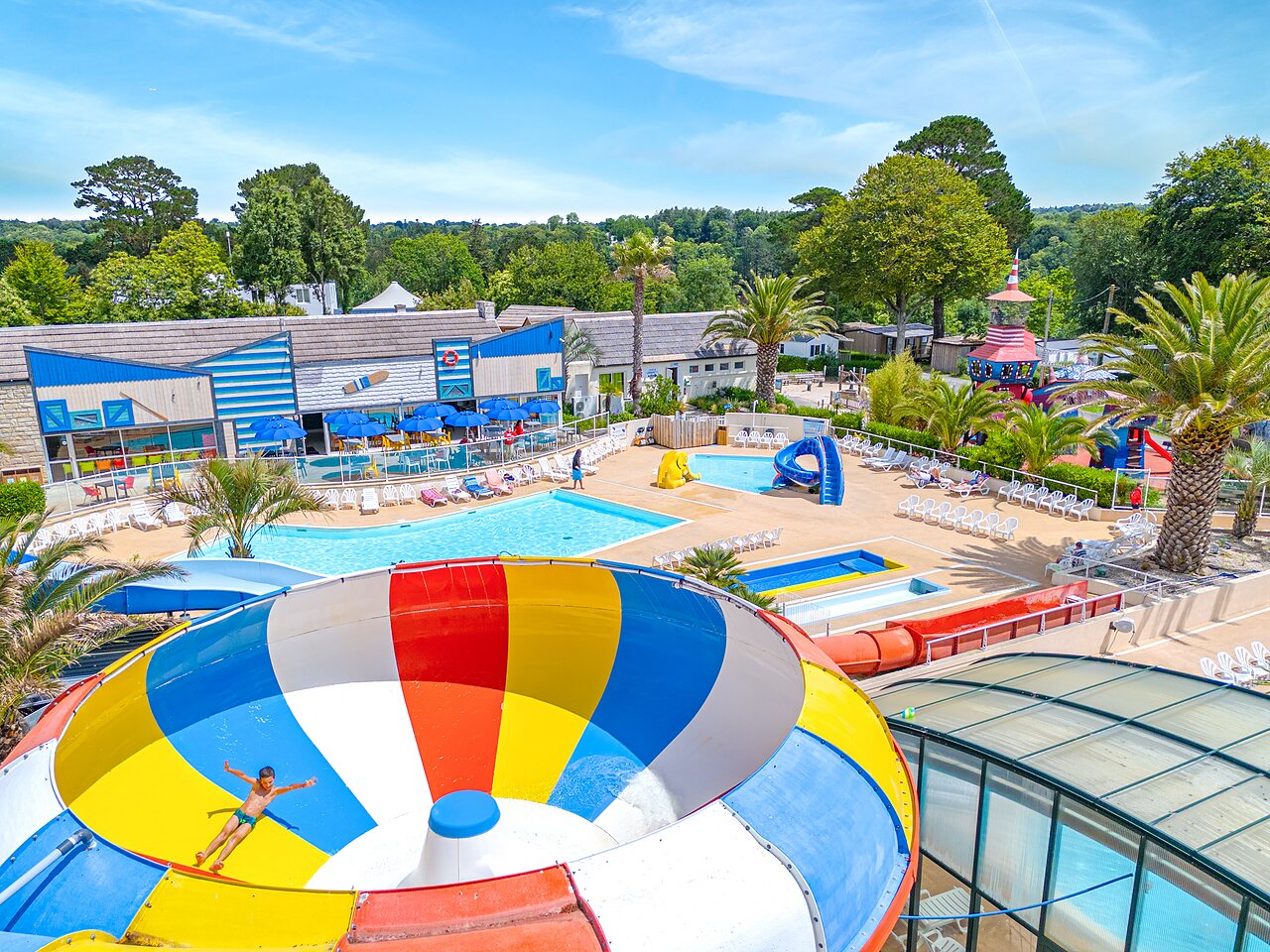 Giant colorful slide, swimming pools and water games at CAPFUN Saint Laurent campsite in LA FORET FOUESNANT (29).