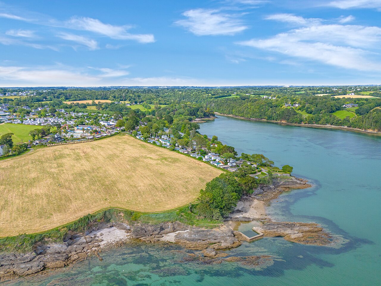 Campsite, Mobile homes and body of water at CAPFUN Saint Laurent campsite in LA FORET FOUESNANT (29).