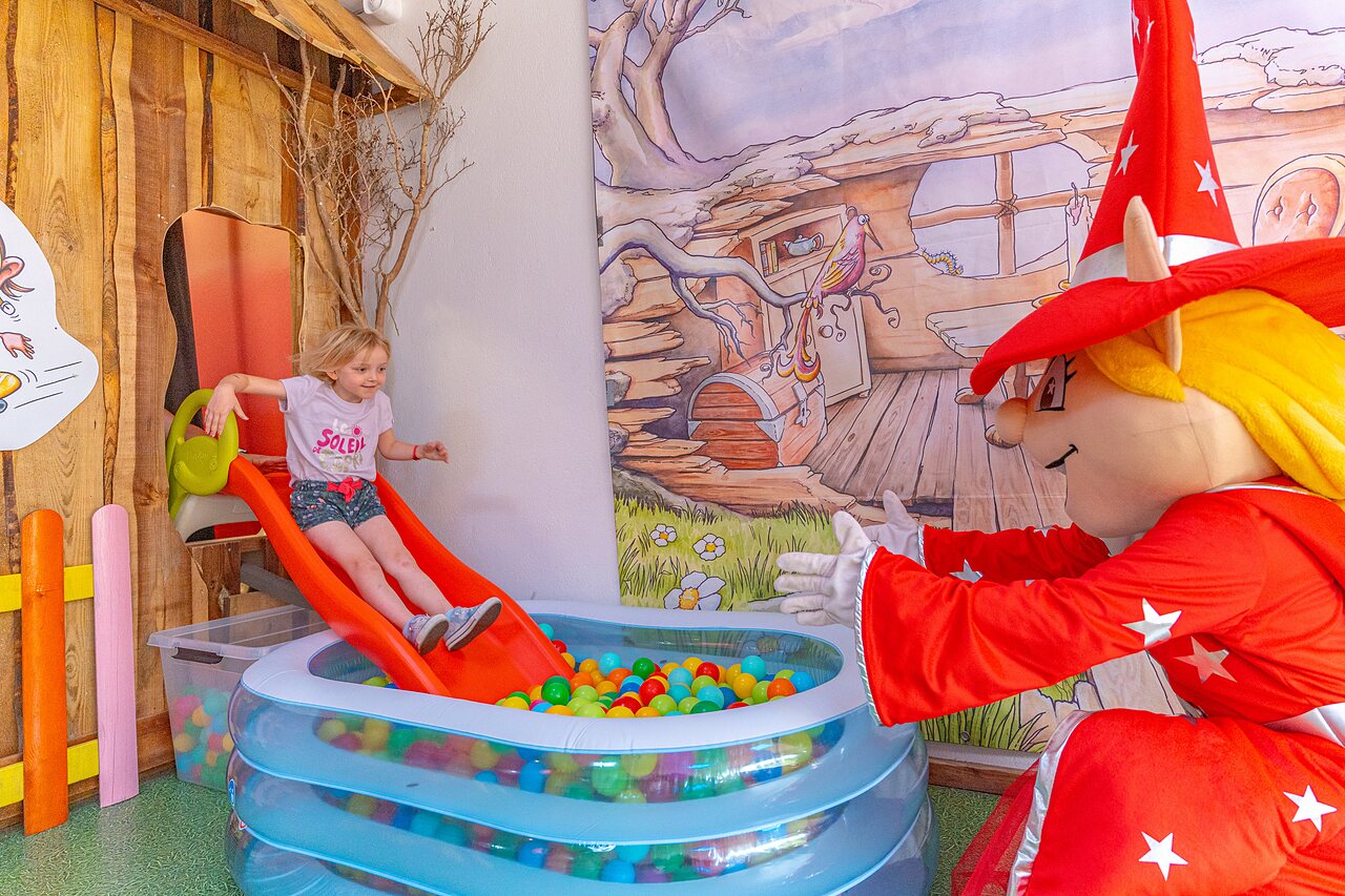 Slide, ball pit and mascot at CAPFUN Saint Laurent campsite in LA FORET FOUESNANT.
