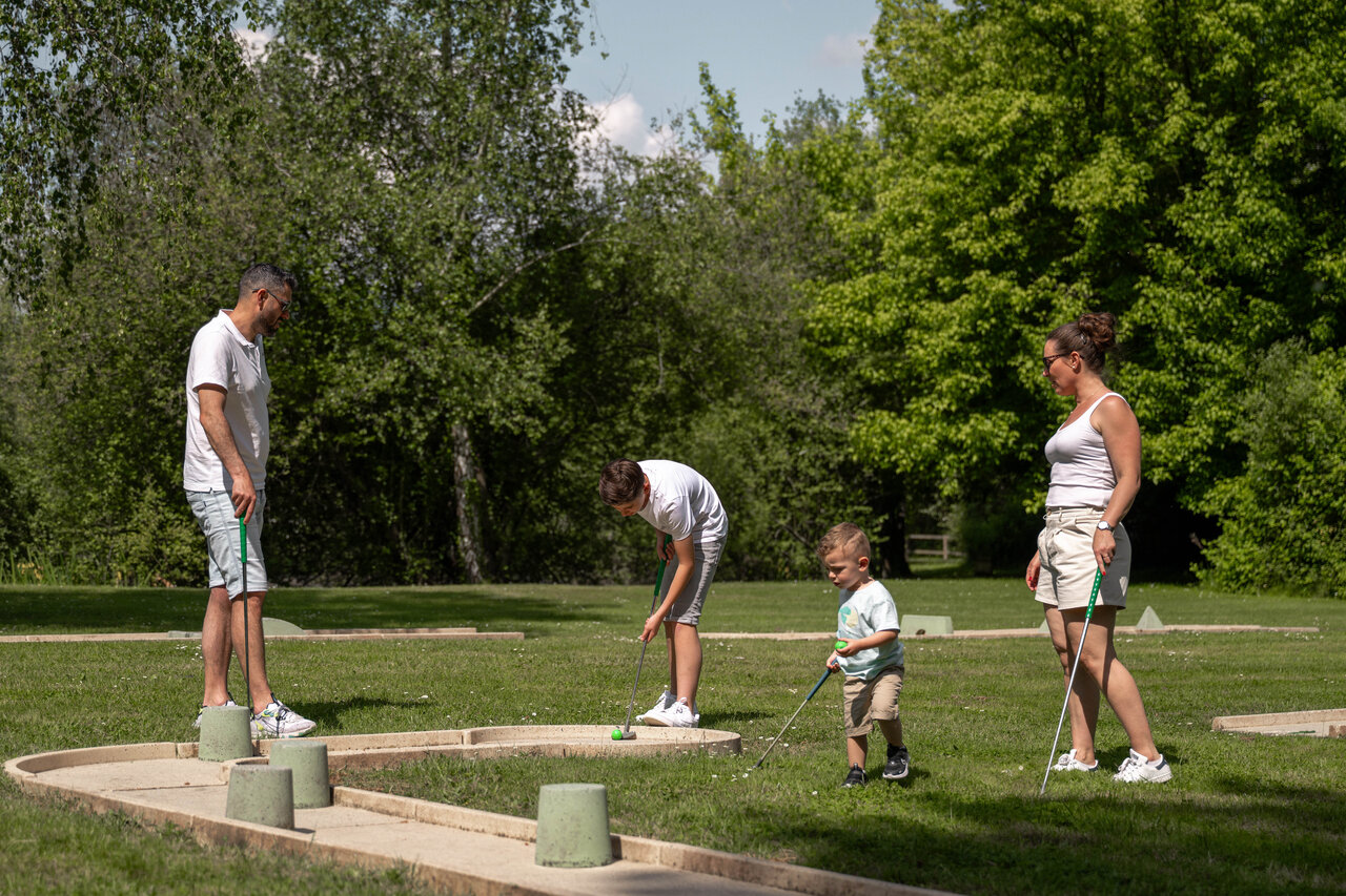 Family mini-golf on green course at CLICOCHIC Les Saules de Cheverny.