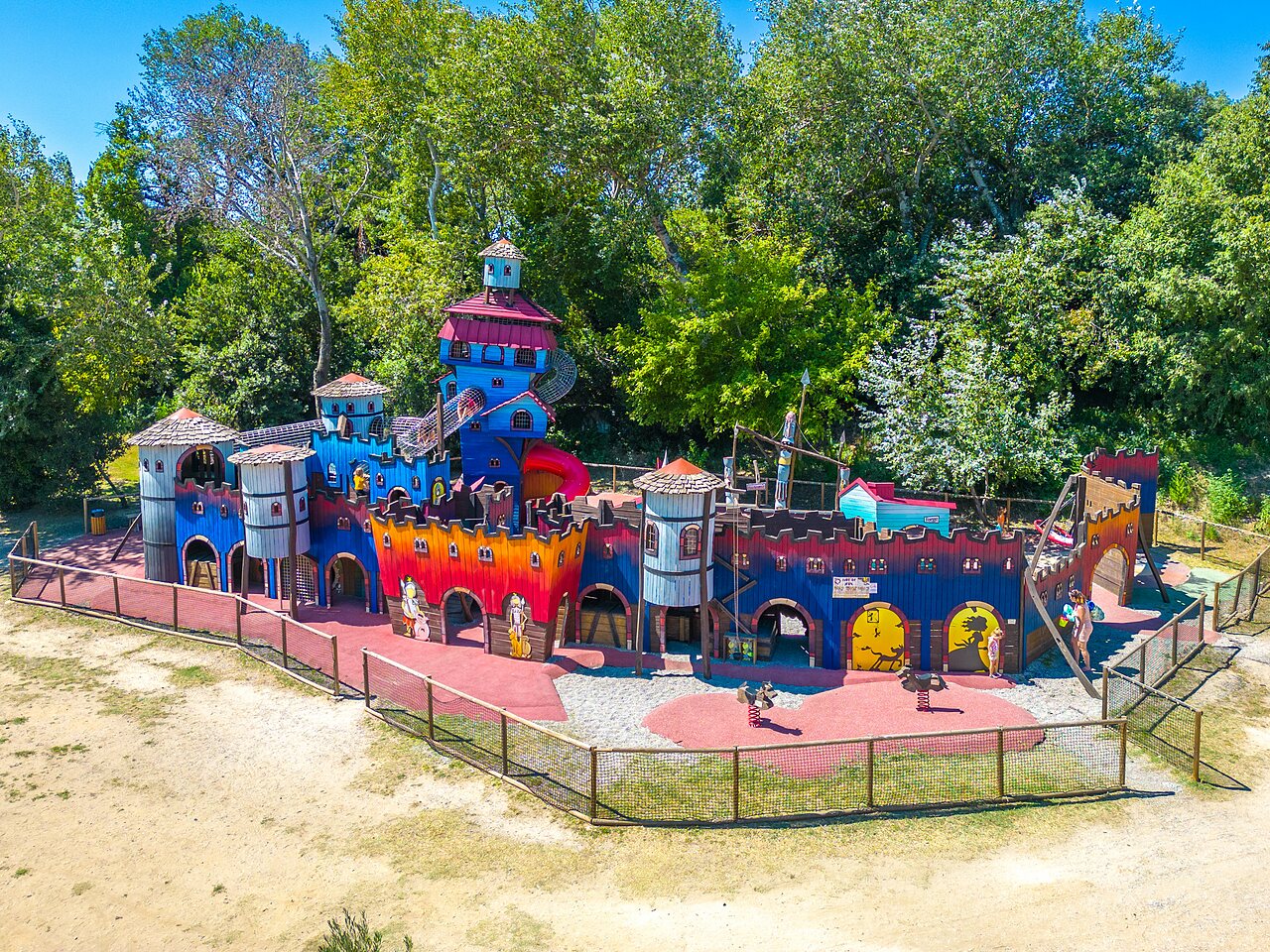 Large colorful play castle for children at CAPFUN Soubeyranne campsite in REMOULINS (30).