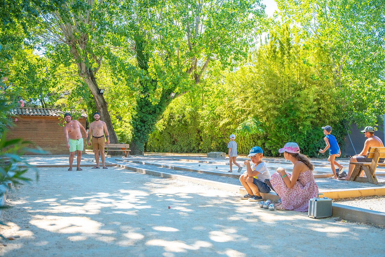 Shaded family p�tanque game at CAPFUN Soubeyranne campsite in REMOULINS (30).