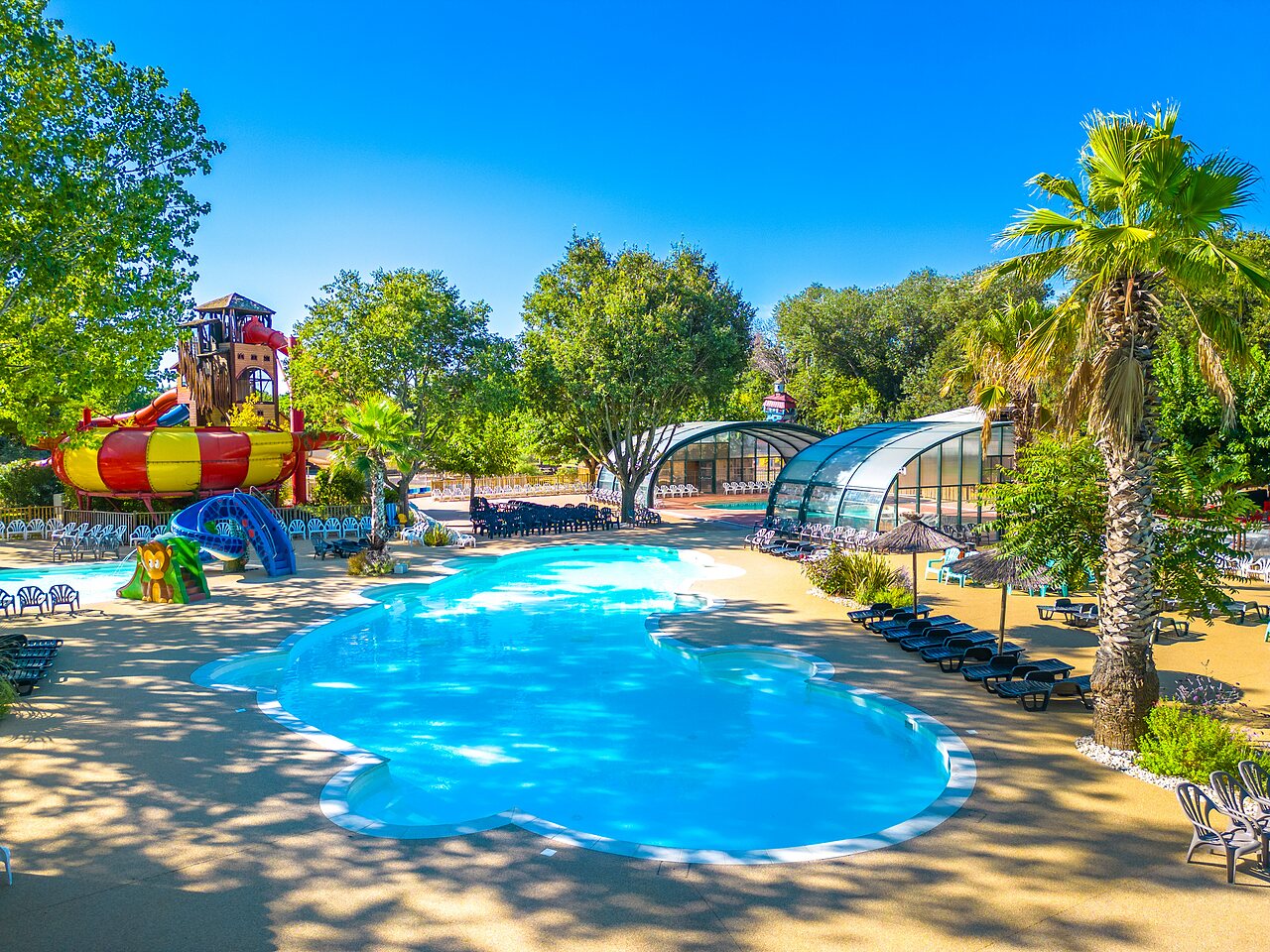 Large water park with slides and covered pools at CAPFUN Soubeyranne campsite in REMOULINS (30).