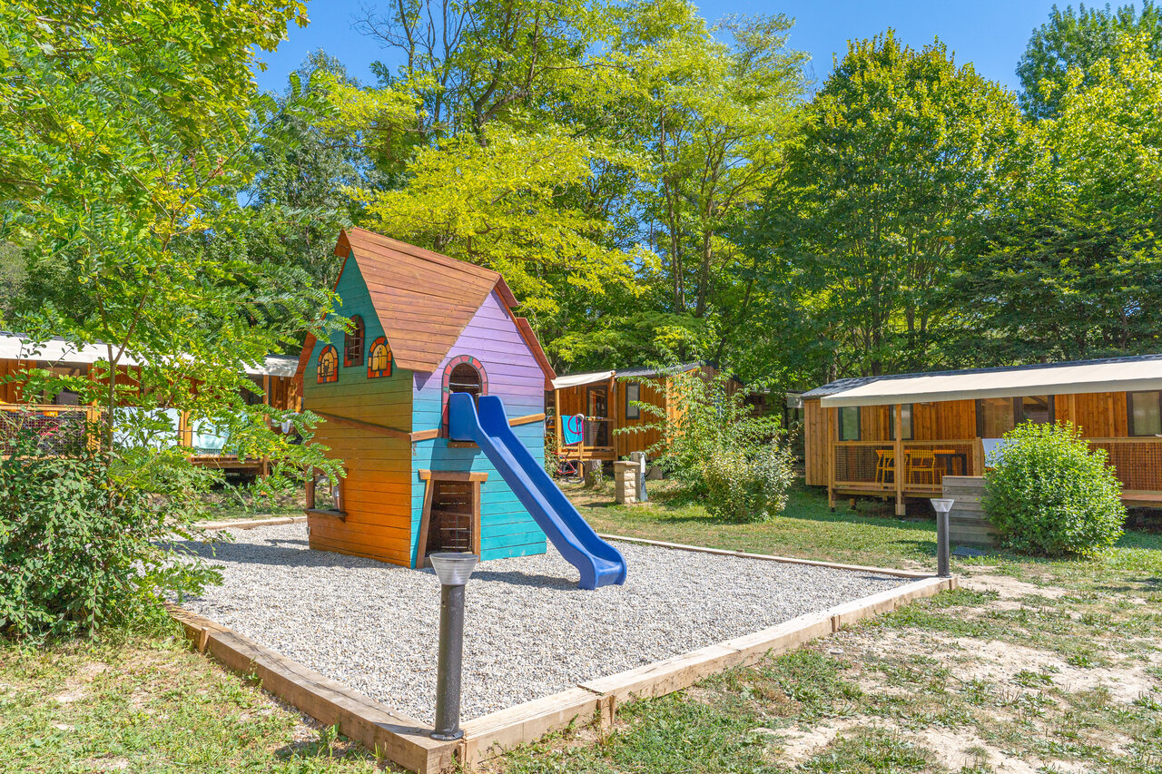 Colorful playground, slide, Mobile homes at CLICOCHIC Source du Jabron campsite Comps.