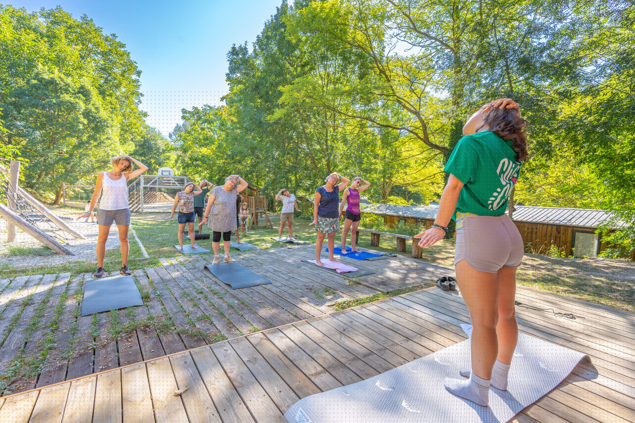 Outdoor yoga class for adults at CLICOCHIC Source du Jabron campsite, Comps (26).