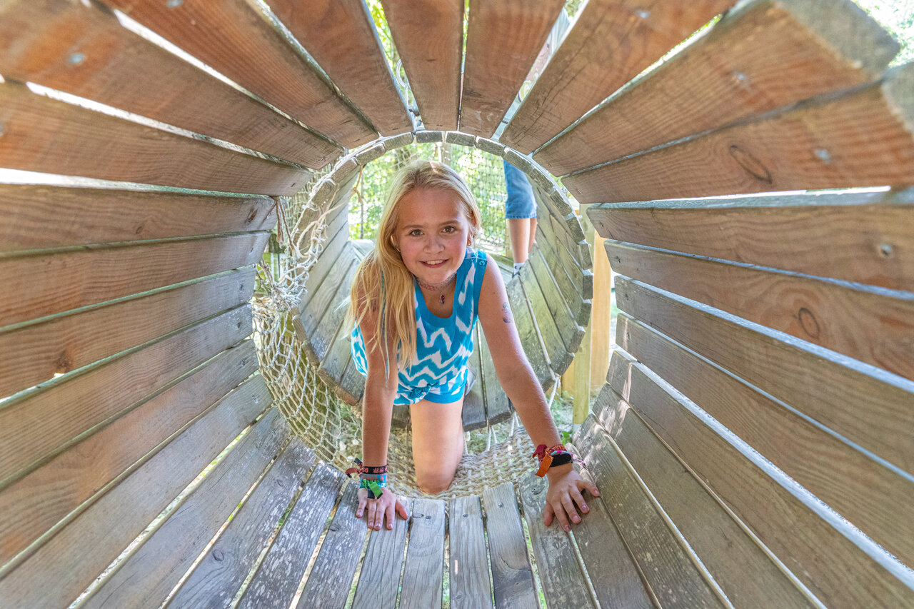 Child in play tunnel at CLICOCHIC Source du Jabron campsite in Comps.