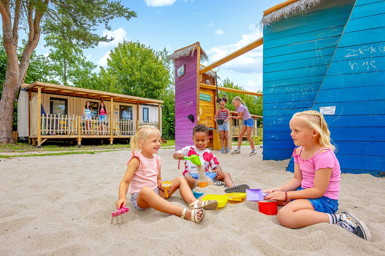 Children playing in sand, playground at Capfun campsite in Rheezerveen.