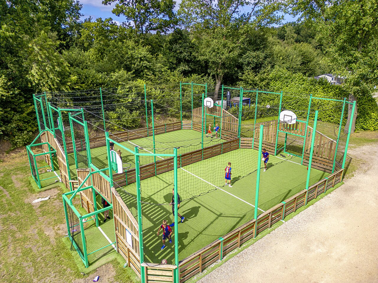 Multi-sport court with children playing at CAPFUN Vakantiepark Capfun het Stoetenslagh, Rheezerveen.