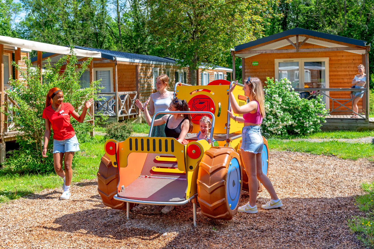 Children and animator on tractor playground at CAPFUN Suzel Sainte-Croix-en-Plaine (68).