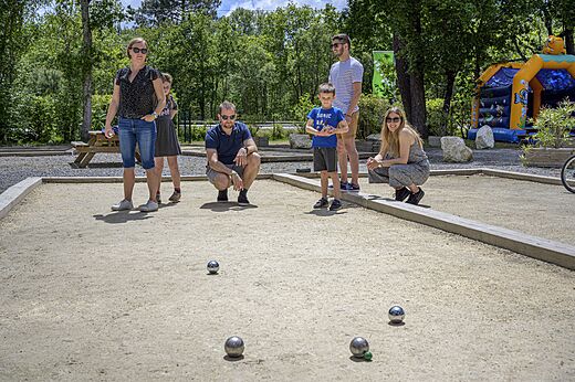 Family playing p�tanque on the court at CAPFUN Talaris Vacances campsite.