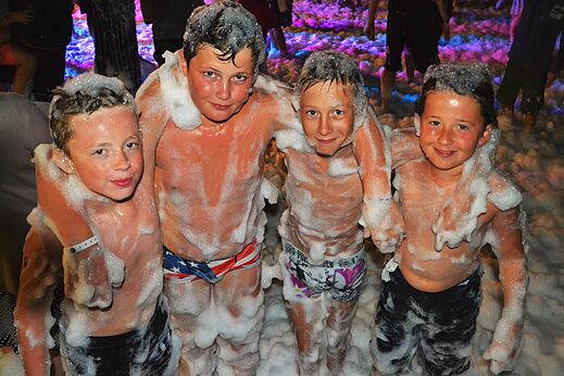 Happy children at foam party, entertainment at CAPFUN Talaris Vacances campsite in Lacanau.