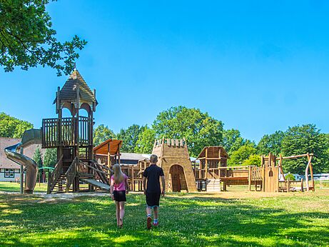 Large wooden playground with slide and structures at CAPFUN Tecklenburg campsite in Tecklenburg-Leeden (49).