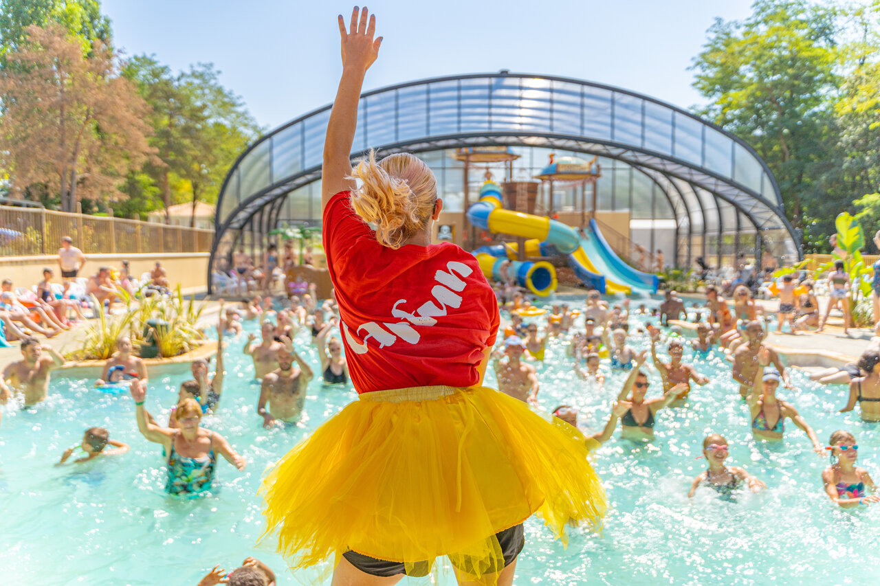 Animator leading aquagym in pool with slides at CAPFUN Temps Libre campsite in BOUGE CHAMBALUD (38).