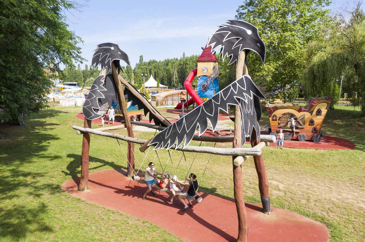 Playground, swing, play structures at CAPFUN Temps Libre campsite BOUGE CHAMBALUD (38).