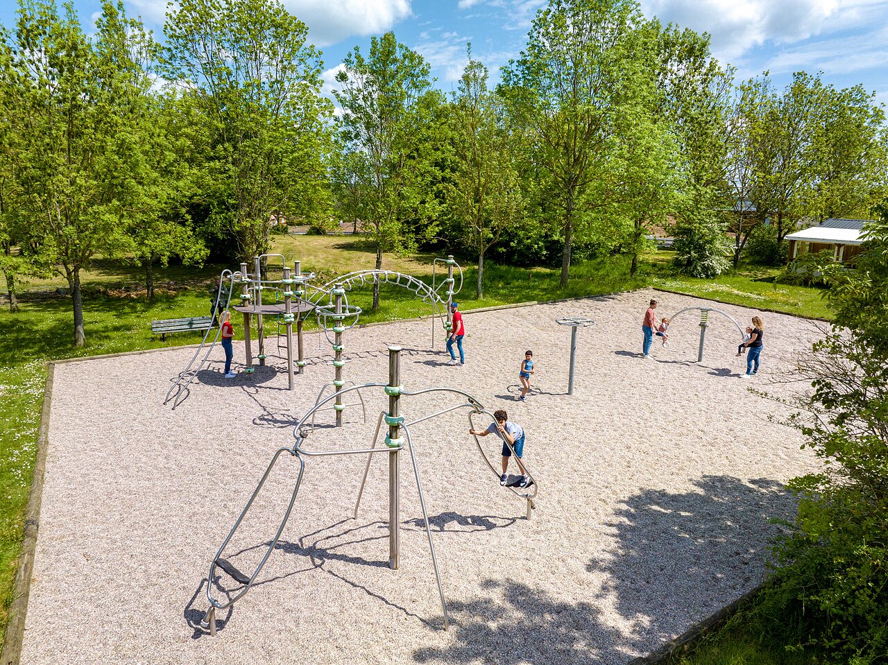Modern playground with climbing structures at CAPFUN Tensch Jolie campsite.