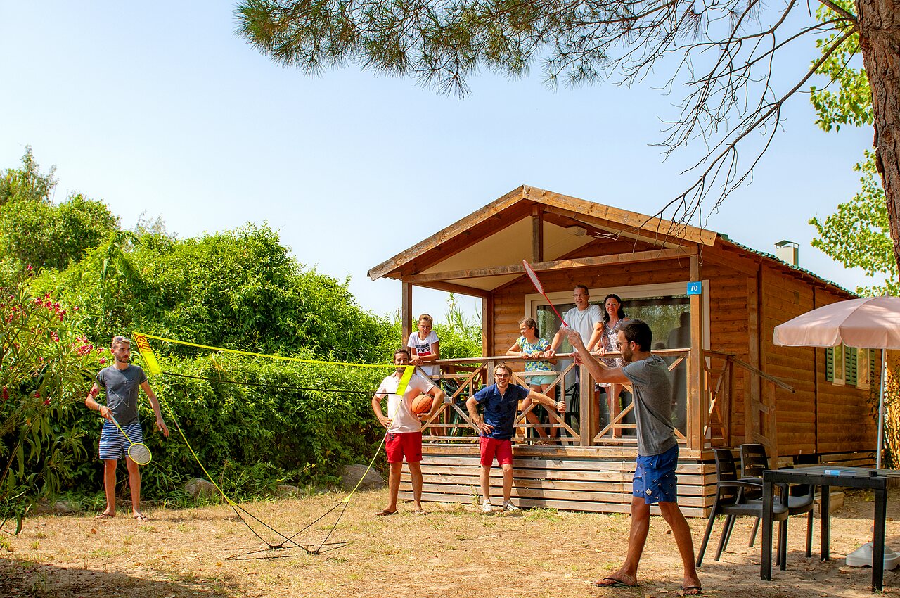 Mobile home and family playing badminton at CAPFUN Teorix, MARSEILLAN PLAGE.