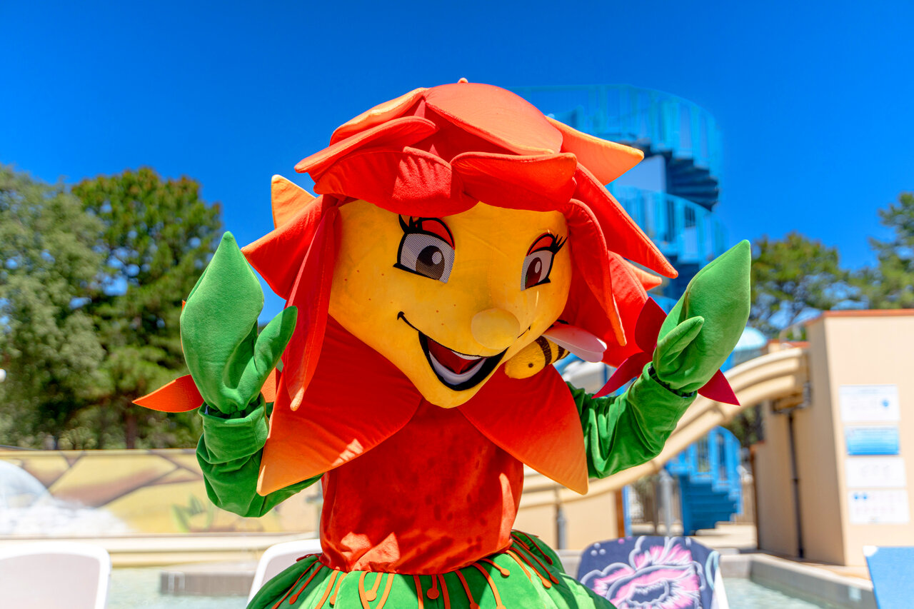 Smiling flower mascot, water slide at CLICOCHIC Texas campsite, Argel�s sur Mer (66).