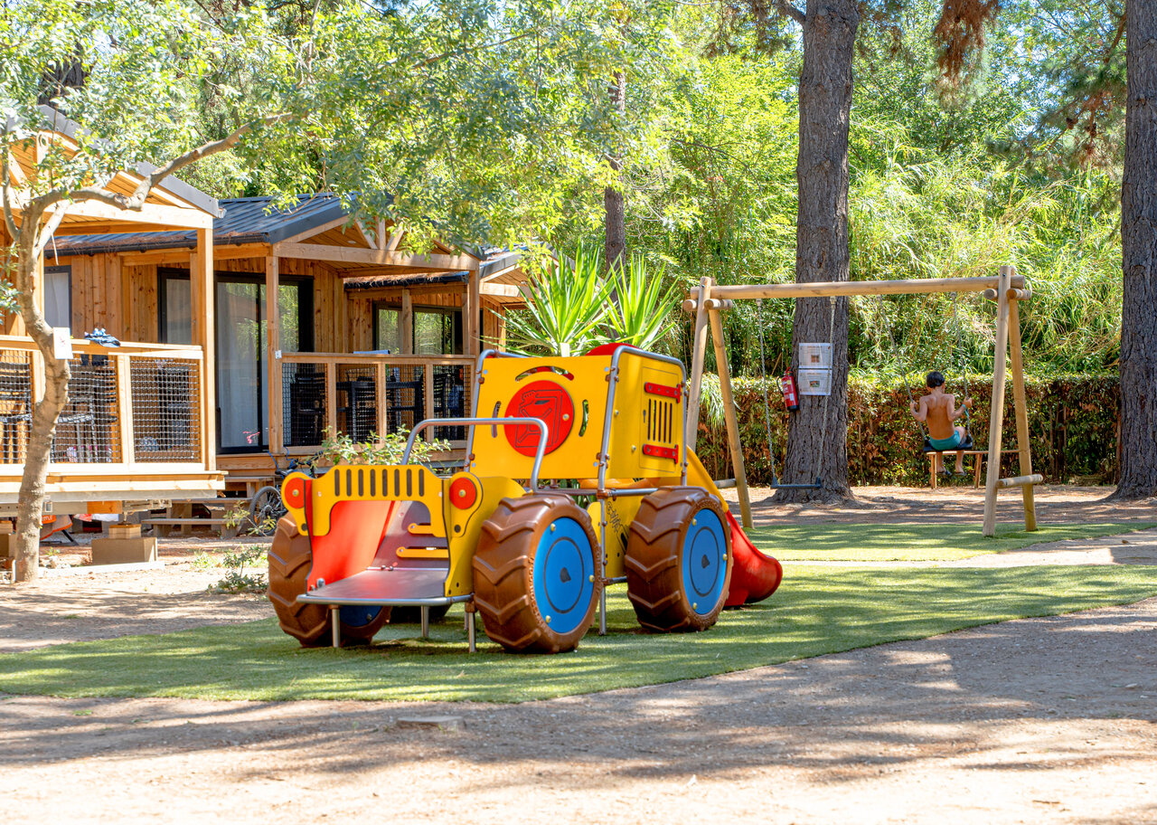 Slide, swing, mobile homes at CLICOCHIC Texas camping in Argel�s sur Mer (66).