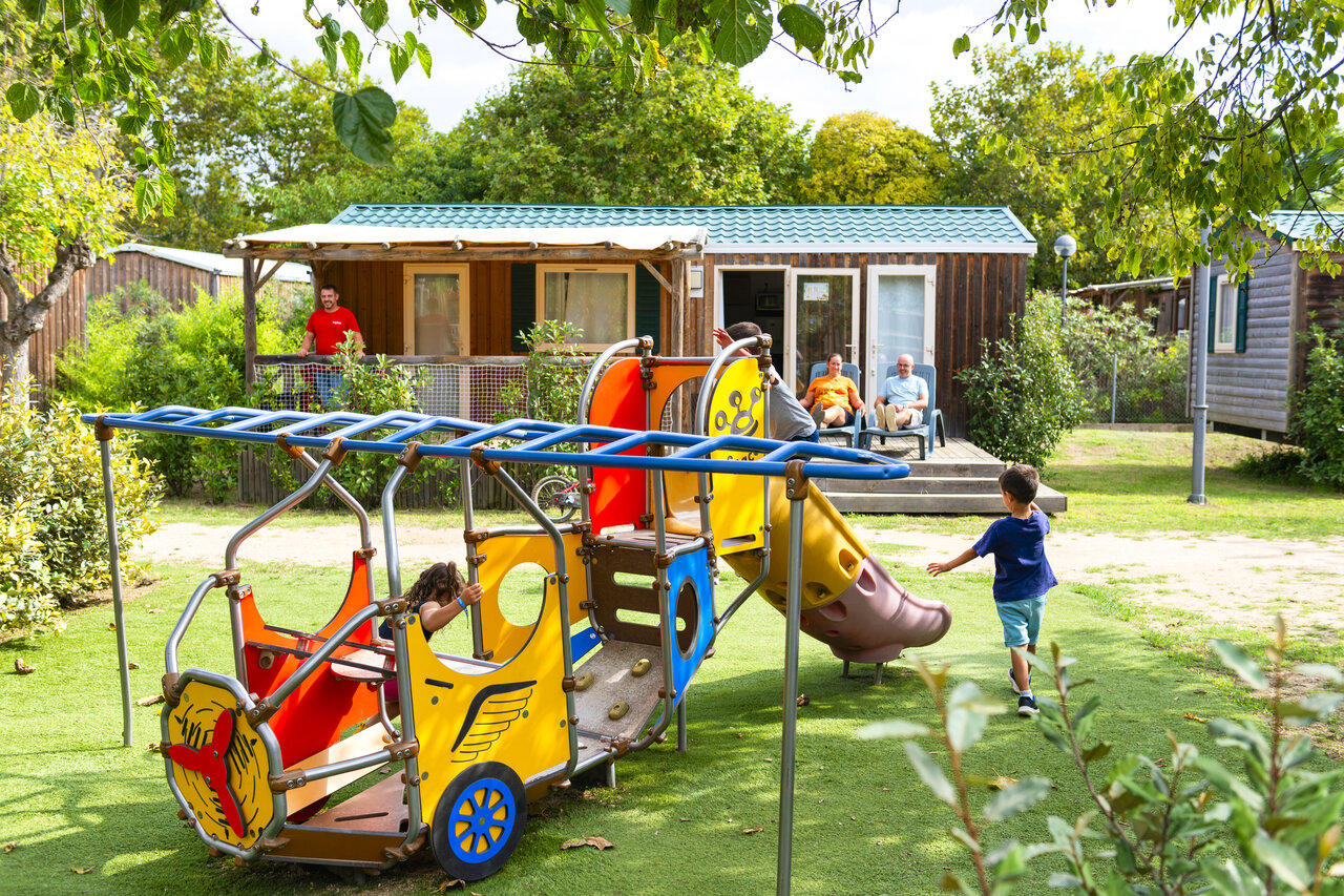 Colorful playground with slide and play structure at CAPFUN Tordera-Nacions campsite.