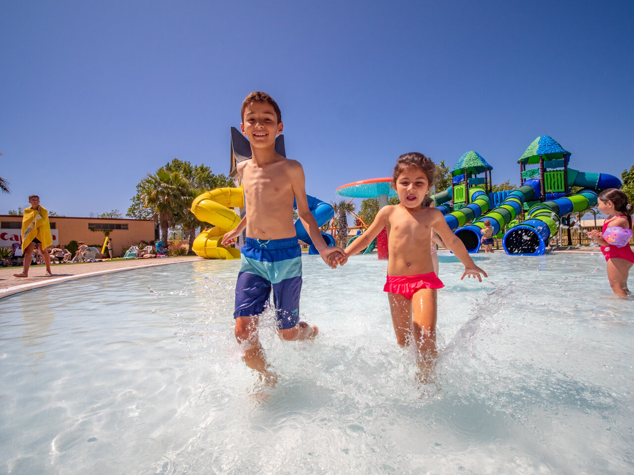 Children splashing in the pool, water slides, CAPFUN Tordera-Nacions campsite in Malgrat de Mar.