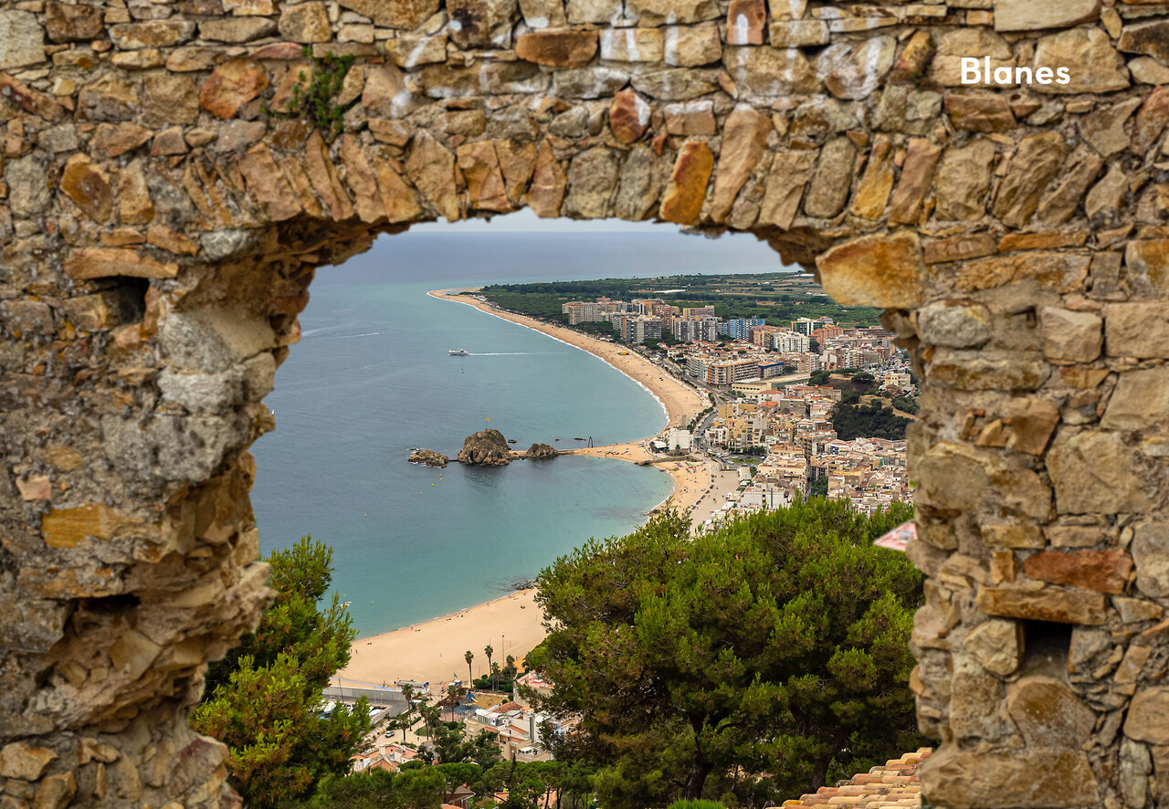 Panoramic view of Blanes, a coastal town with beach and Mediterranean Sea.