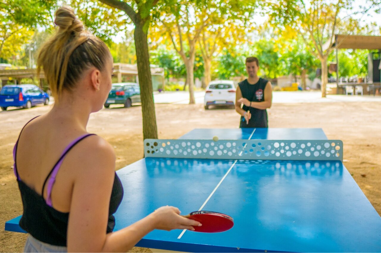 Table tennis game on blue table at CAPFUN Tordera-Nacions campsite in Malgrat de Mar.