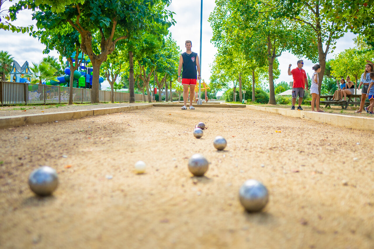 P�tanque court with players and boules at CAPFUN Tordera-Nacions campsite, Malgrat de Mar (08).