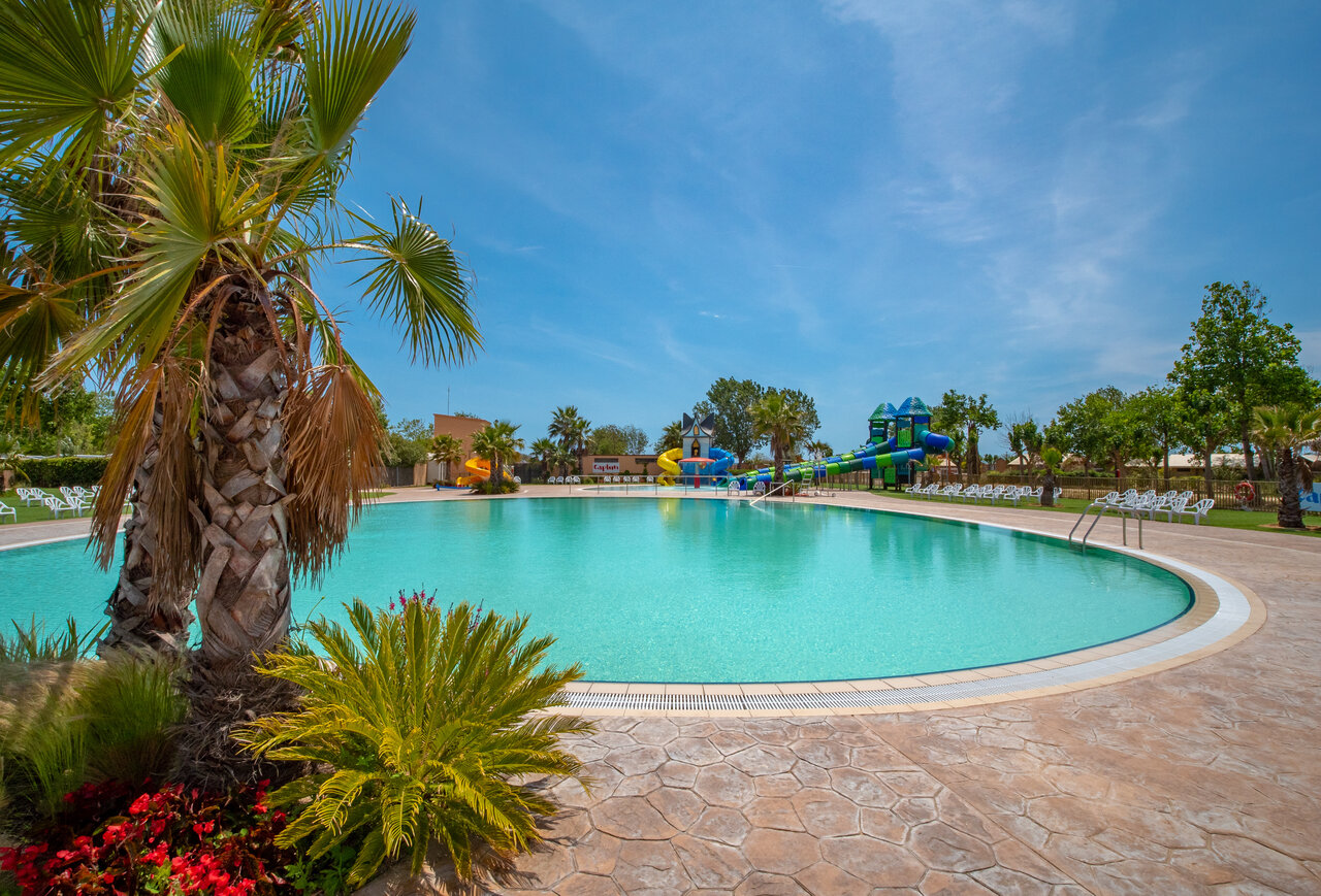 Large outdoor swimming pool with water slides and play structures at CAPFUN Tordera-Nacions campsite in Malgrat de Mar (08).
