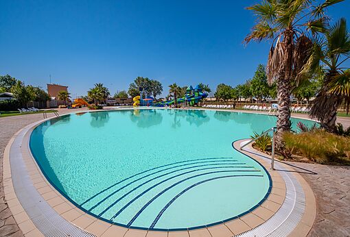 Large outdoor swimming pool with water slides at CAPFUN Tordera-Nacions campsite in Malgrat de Mar (08).