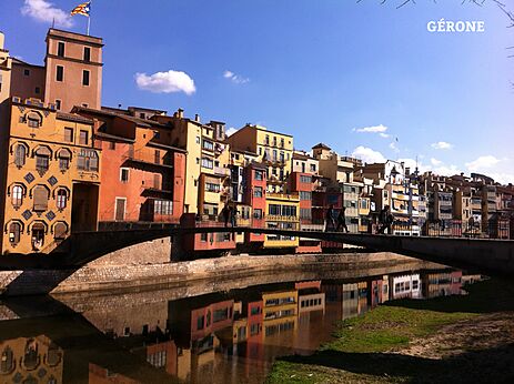 Colorful houses along the Onyar River in Girona, a city to visit.