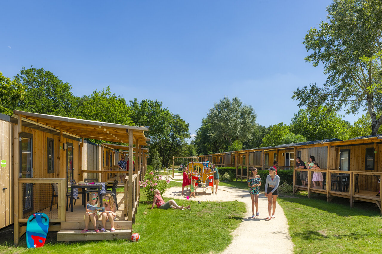 Modern mobile homes with terraces and playground at CAPFUN Celeste campsite in Breuillet (17).