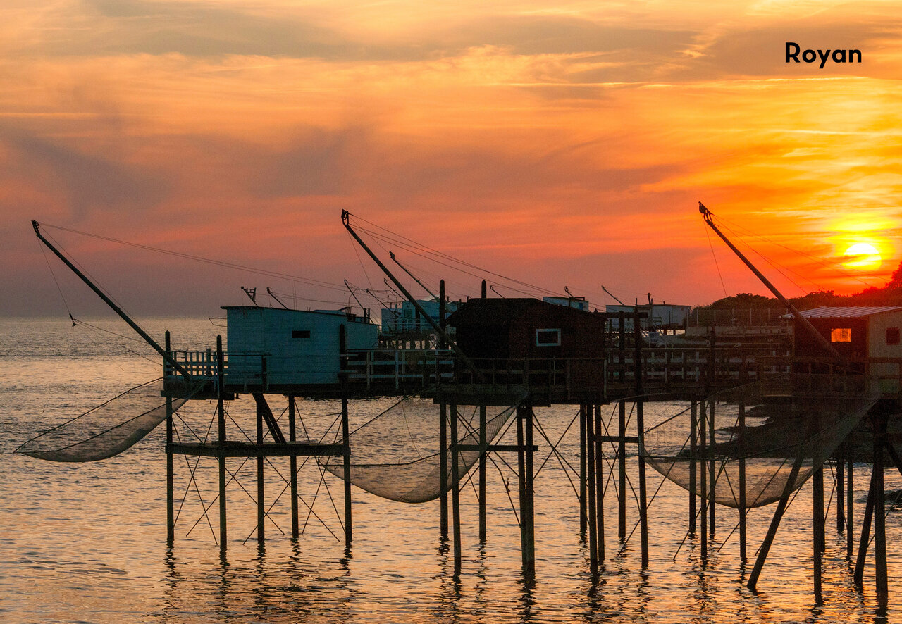 Traditional fishing huts at sunset in Royan, Charente-Maritime, a must-visit.