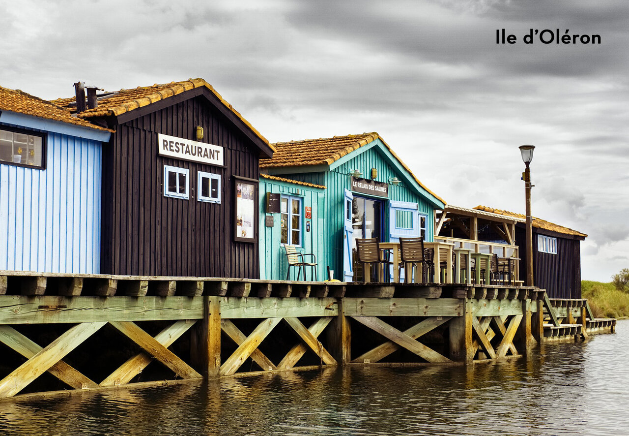 Colorful oyster huts on stilts, restaurant, to visit on Ol�ron Island.