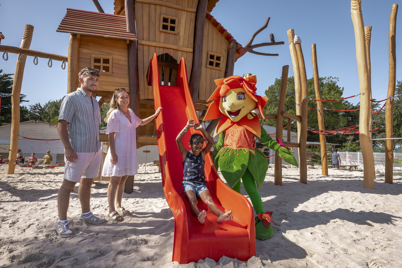 Playground with slide, child and mascot at CLICOCHIC Trois Ch�nes campsite in Pornichet (44).