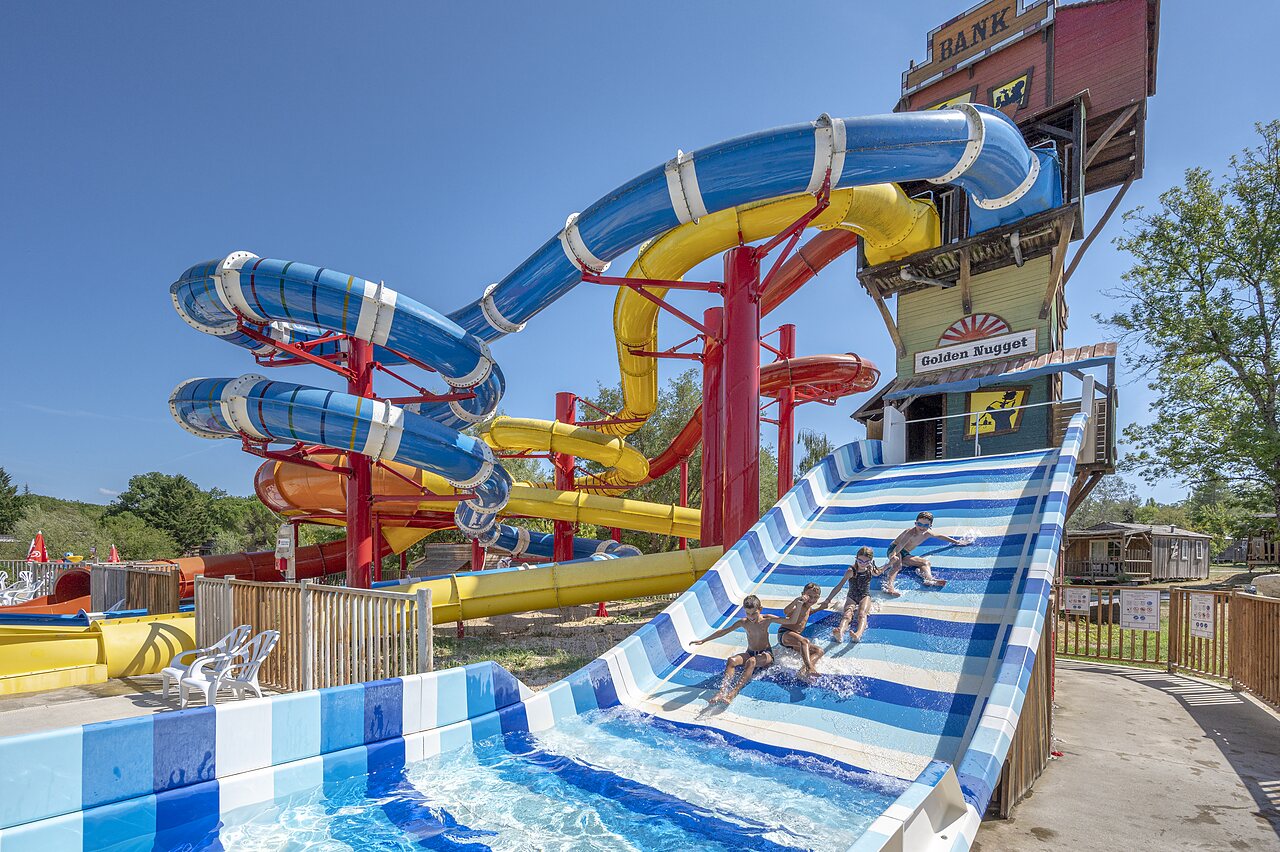 Giant water slides and children at CAPFUN Ullule campsite in Tournon d'Agenais.
